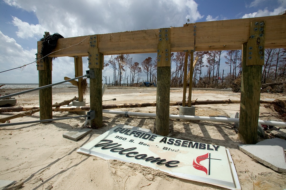 Foundation pilings and a plastic sign are all that remain of a building at the historic Gulfside Assembly grounds in Waveland, Miss., following Hurricane Katrina in 2005. 