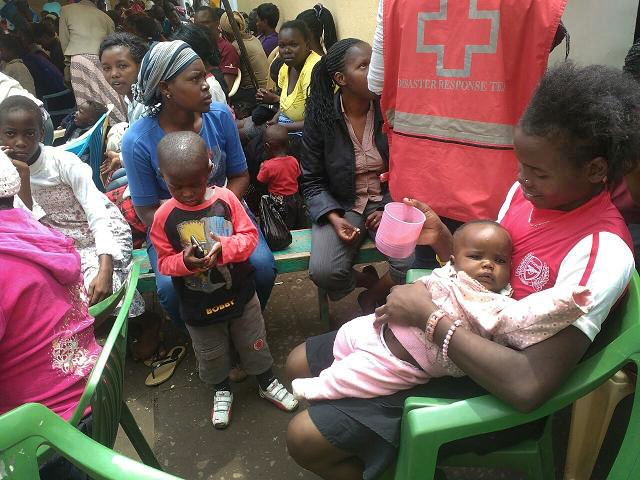 Women and children who were in the collapsed building gather in a Red Cross tent. Photo by Anthony Maiga, UMNS