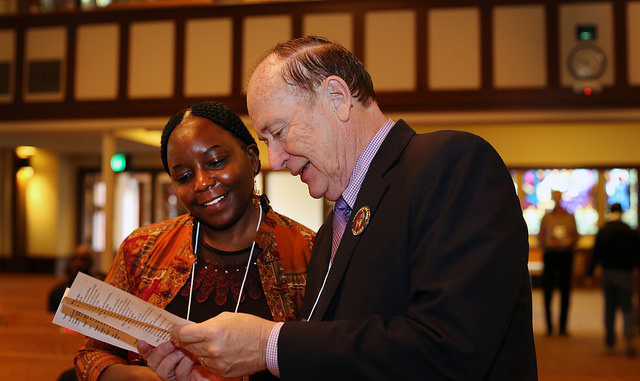 Dr. Pauline Muchina and the Rev. Donald E. Messer look over the program before the start of  "AIDS is Not Over!...Global Issues and the Church" held at Rose City Park United Methodist Church in Portland, Ore. 