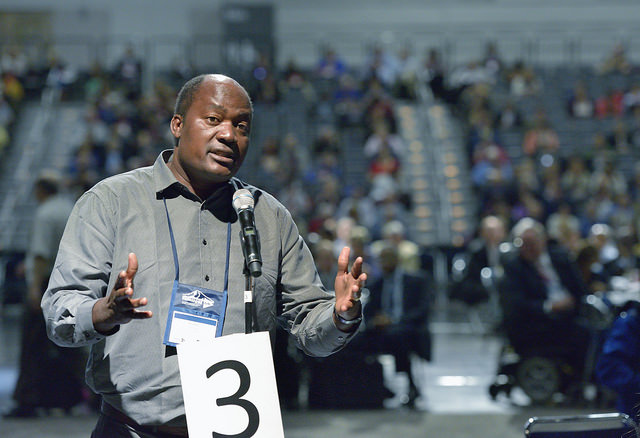The Rev. Forbes Matonga, a clergy delegate from the West Zimbabwe annual conference, speaks to the United Methodist General Conference in Portland, Ore., on May 11. Matonga spoke in opposition to proposed Rule 44, which would allow small discussion groups to be used to handle sensitive themes. Photo by Paul Jeffrey, UMNS