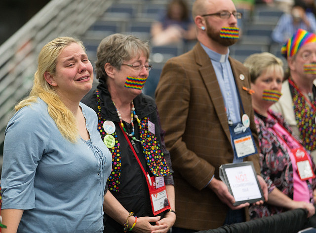 Supporters of full rights for LGBTQ persons in the life of The United Methodist Church, many with their mouths taped shut, stand outside the bar of the 2016 United Methodist General Conference in Portland, Ore., to symbolize the way LBGTQ people feel they are silenced by the church. Photo by Mike DuBose, UMNS