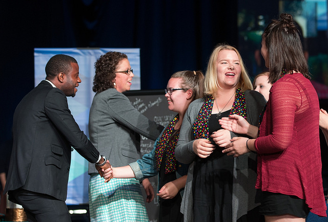 Peter Cibuabua of the Central Congo Conference (left) and Chelsea Spyres of the Peninsula-Deleware Conference (second from left) celebrate with other presenters at the conclusion of the young people's address at the 2016 United Methodist General Conference in Portland, Ore. Photo by Mike DuBose, UMNS.