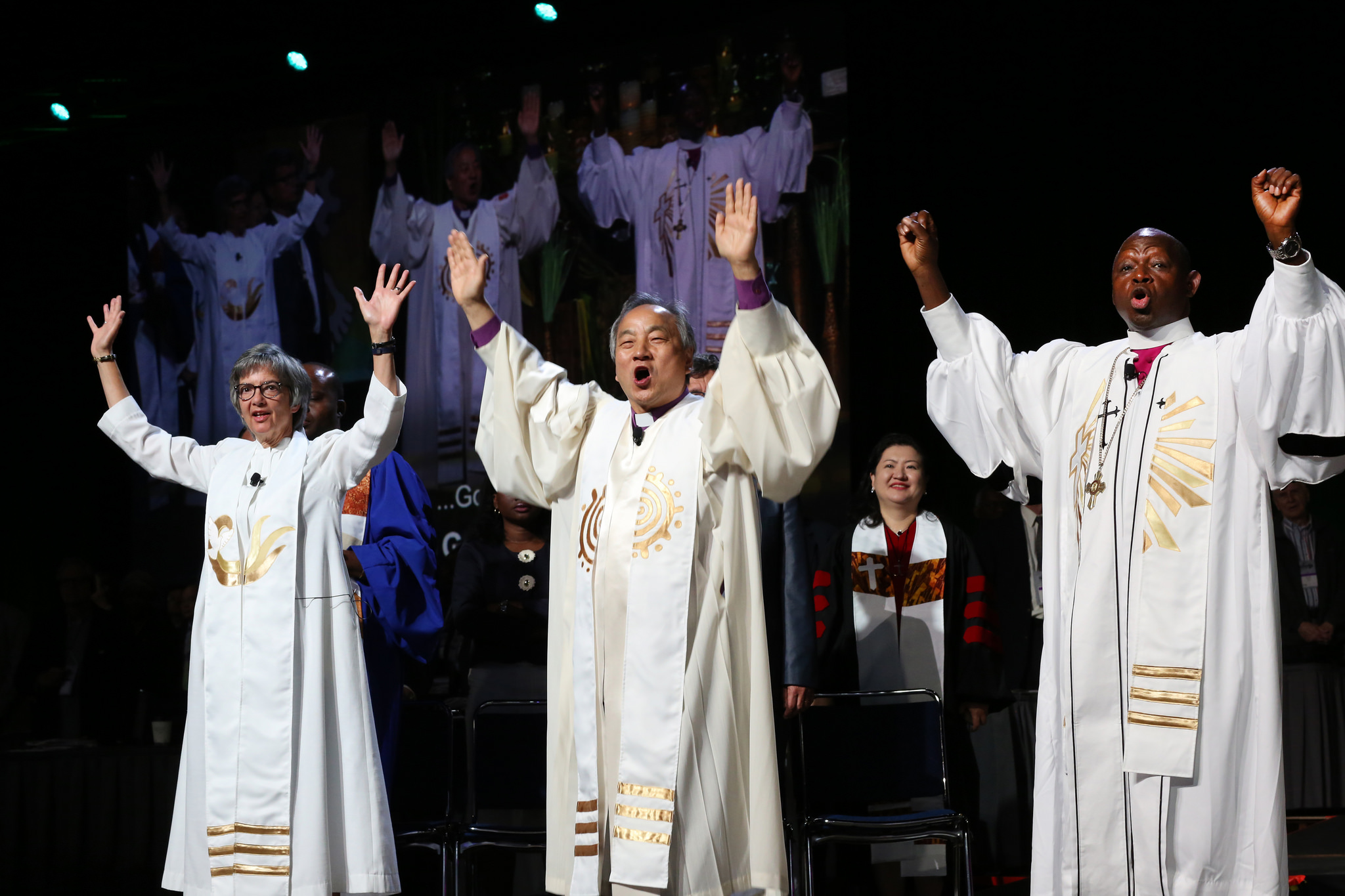 (From left) Bishops Hope Morgan Ward, Hee-Soo Jung, and John Yambasu shout, "Go" following the end of the commissioning of missionaries at the May 19 United Methodist General Conference in Portland, Ore. Photo by Kathleen Barry, UMNS