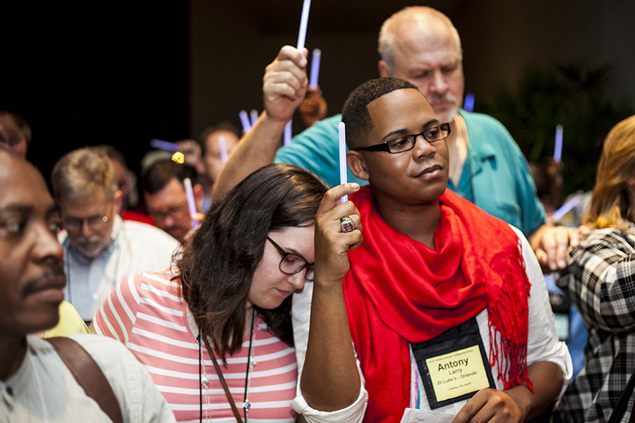 Members of the Florida Conference of The United Methodist Church hold glow sticks during a prayer vigil in response to the mass shooting at Pulse, a gay nightclub in Orlando. The vigil was held in Orlando on the first day of the conference’s yearly meeting. Photo by Lance Rothwell, Florida Conference