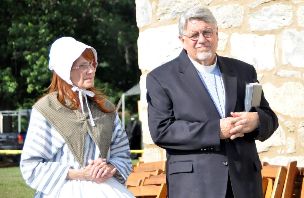 Bishop Peggy Johnson, dressed as Eva Boehm in a red wig and colonial garb, stands next to the Rev. Alfred Day, United Methodist Commission on Archives and History, during a service at Boehm’s Chapel. Photo by John Coleman, Eastern Pennsylvania Conference