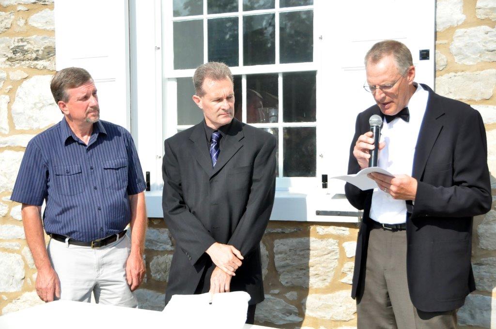 From left, Bishops Lloyd Hoover and Robert Brody listen outside Boehm’s Chapel as Bishop Stephen Weaver reads a proclamation from the Lancaster Mennonite Conference Board of Bishops re-instating Martin Boehm. Photo by John Coleman, Eastern Pennsylvania Conference