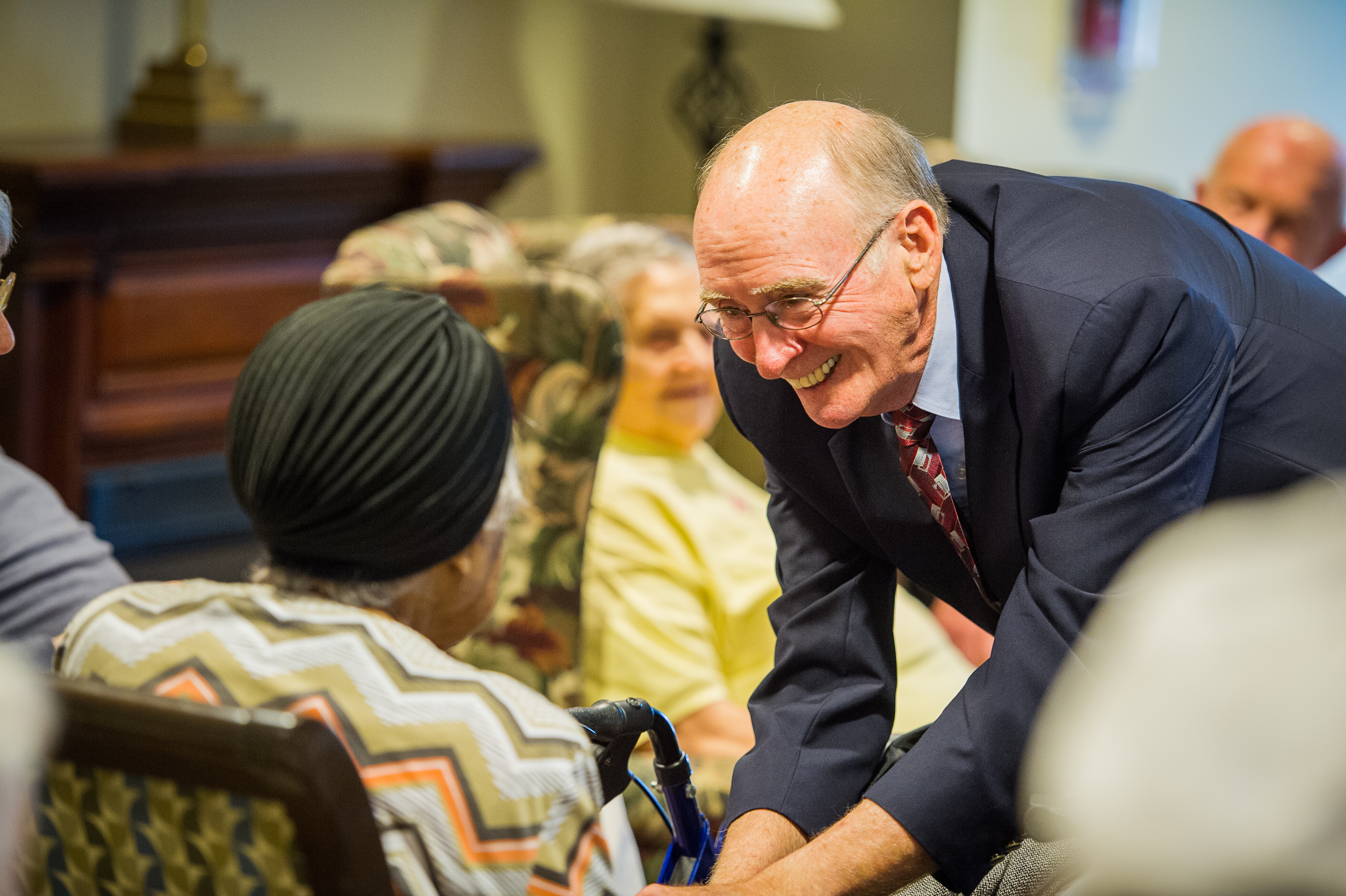 After worship services in the Bethany memory care unit, retired United Methodist Bishop Kenneth Carder goes around the room, greeting each resident by name. Carder is serving as interim chaplain at Bethany, part of the Heritage at Lowman senior community near Columbia, S.C. Photo by Matt Brodie. 