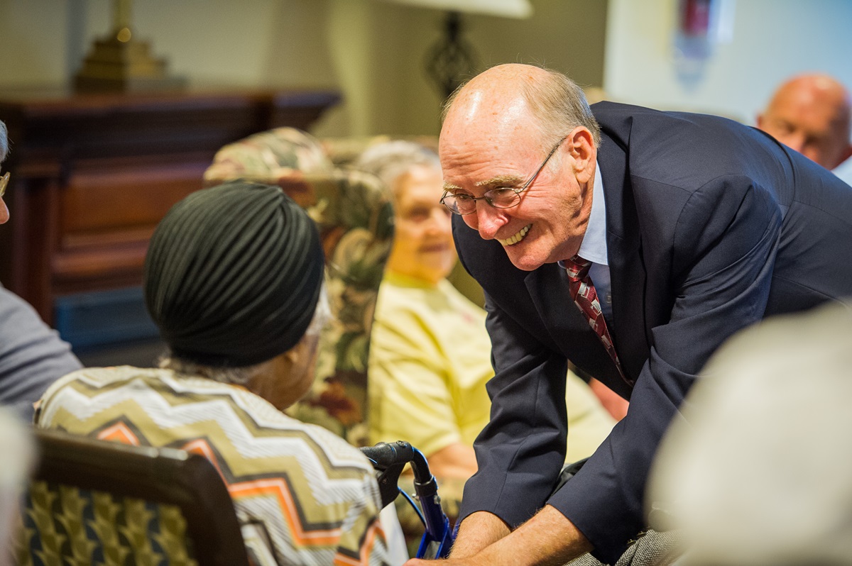 After worship services in the Bethany memory care unit, retired United Methodist Bishop Kenneth Carder goes around the room, greeting each resident by name. Carder is serving as interim chaplain at Bethany, part of the Heritage at Lowman senior community near Columbia, S.C. Photo by Matt Brodie. 