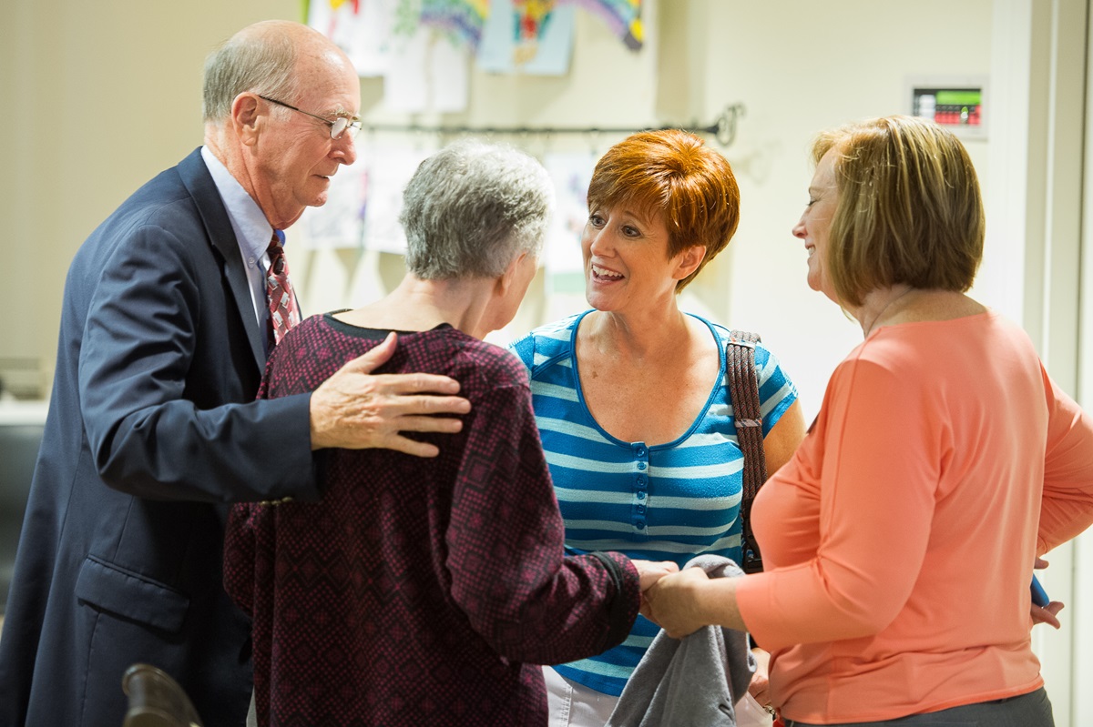 The Carder family gathers at the Bethany memory unit at the Heritage at Lowman senior community near Columbia, S.C. Retired United Methodist Bishop Kenneth Carder  stands with wife, Linda, and their daughters Sheri Carder Hood (second from right) and Sandra Carder Nash (far right). Photo by Matt Brodie.