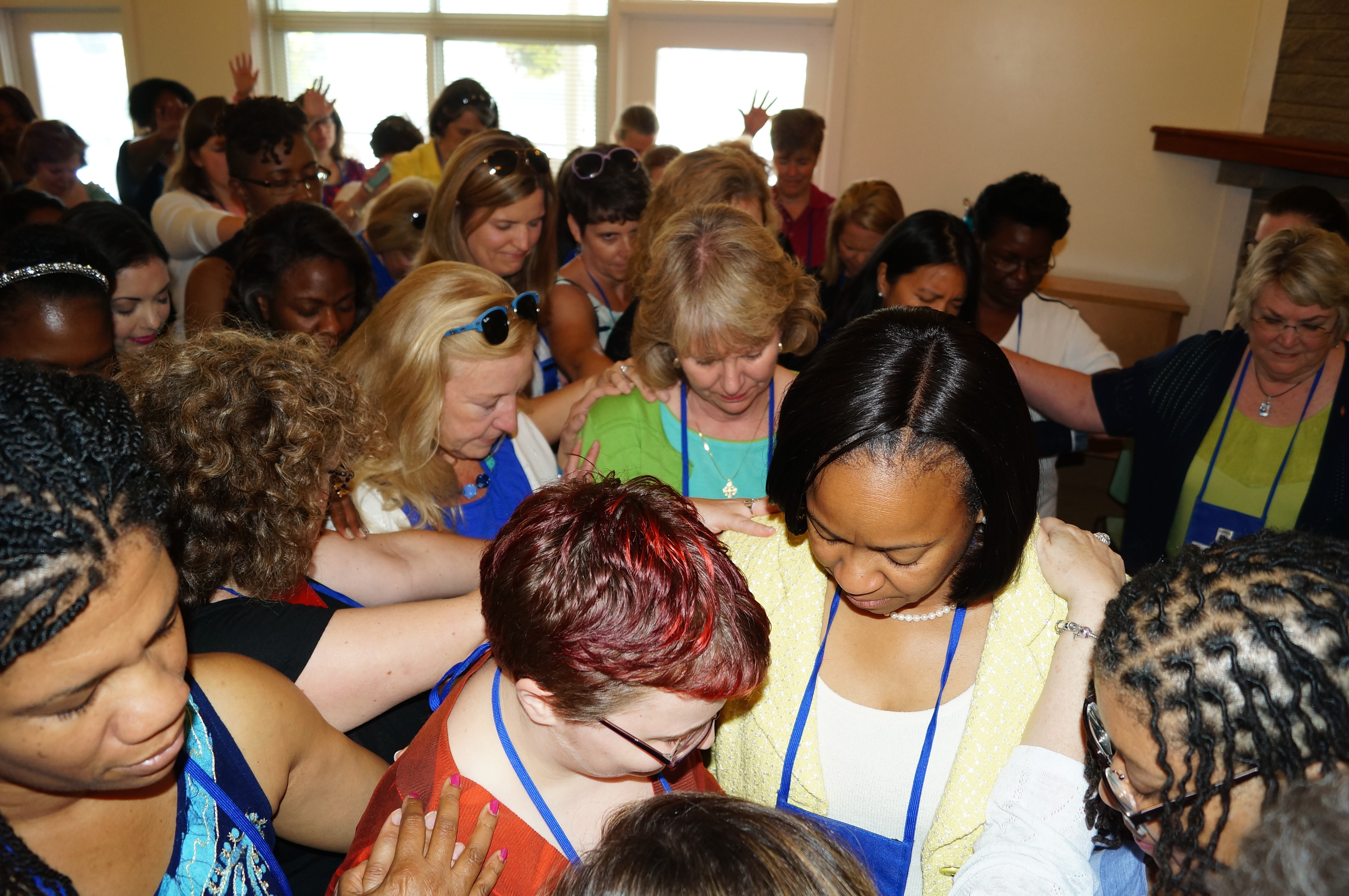 Women in the Southeastern Jurisdiction pray for Bishops-elect Sue Haupert-Johnson (in green-and-blue) and Sharma Lewis (in yellow-and-white) a day before their consecration. United Methodists already have elected a record number of women bishops this year. Photo by Jasmine Haynes, Mississippi Conference