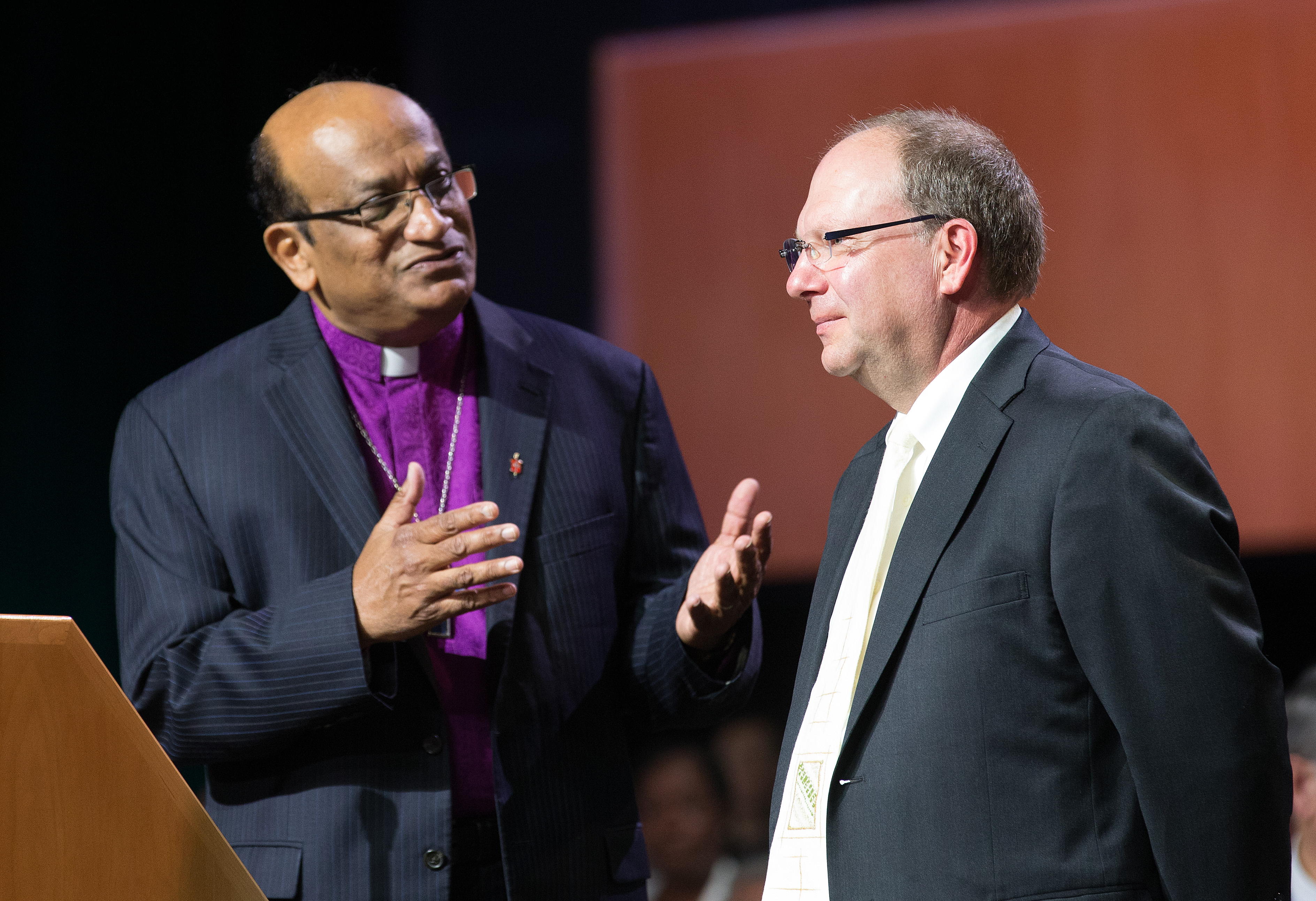 Bishop Sudarshana Devadhar (left) of the Boston Episcopal Area welcomes the Rev. J. Christian Giesler of the Moravian Church (Northern & Southern Provinces) to the 2016 United Methodist General Conference in Portland, Ore. Photo by Mike DuBose, UMNS