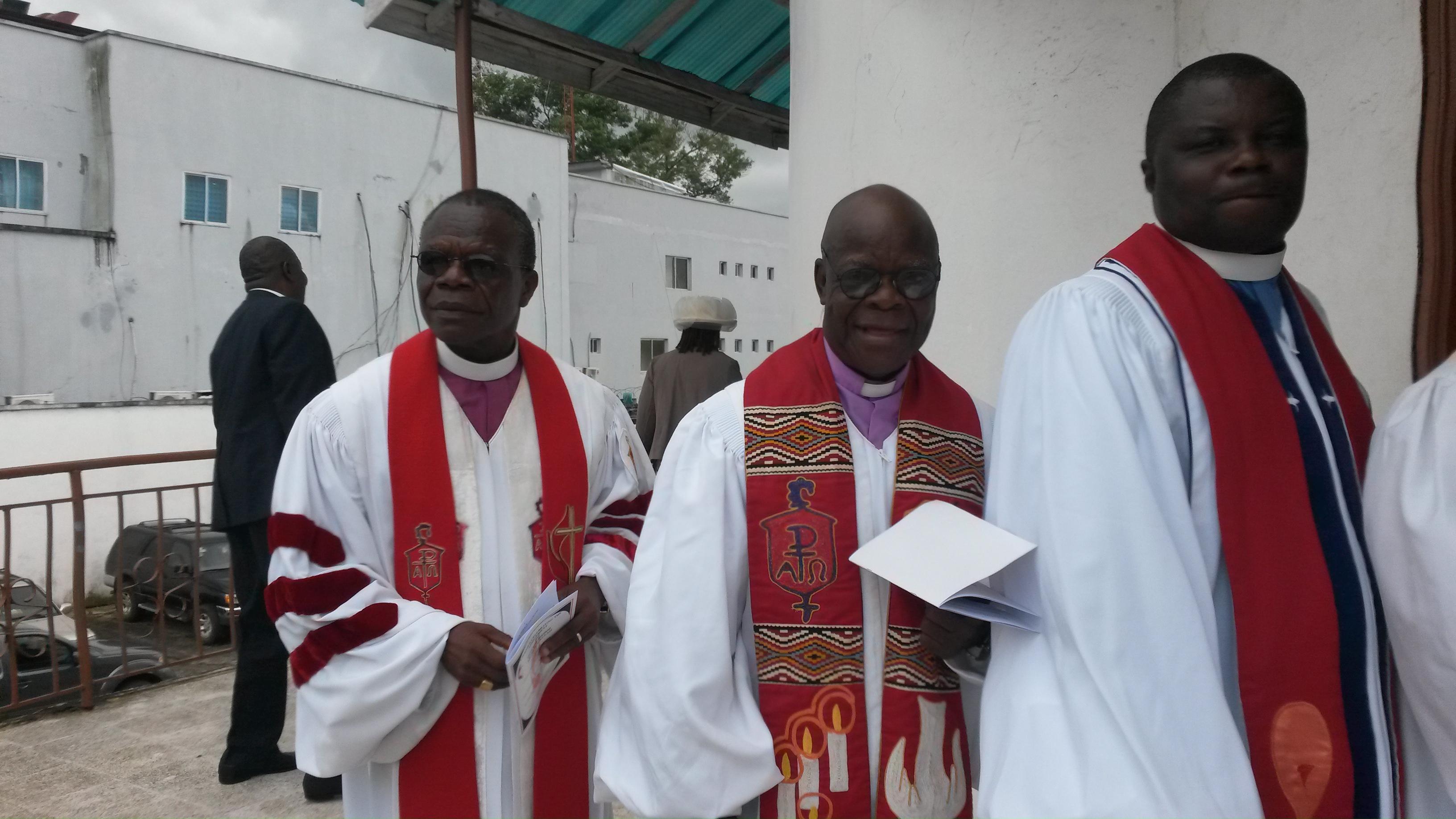 Bishop John Innis, left, Bishop Arthur Kulah, middle, and the Rev. Christopher Marshall, right, process in for the ceremony to install Kulah as interim bishop of the Liberia Conference. Photo by Julu Swen, UMNS.

