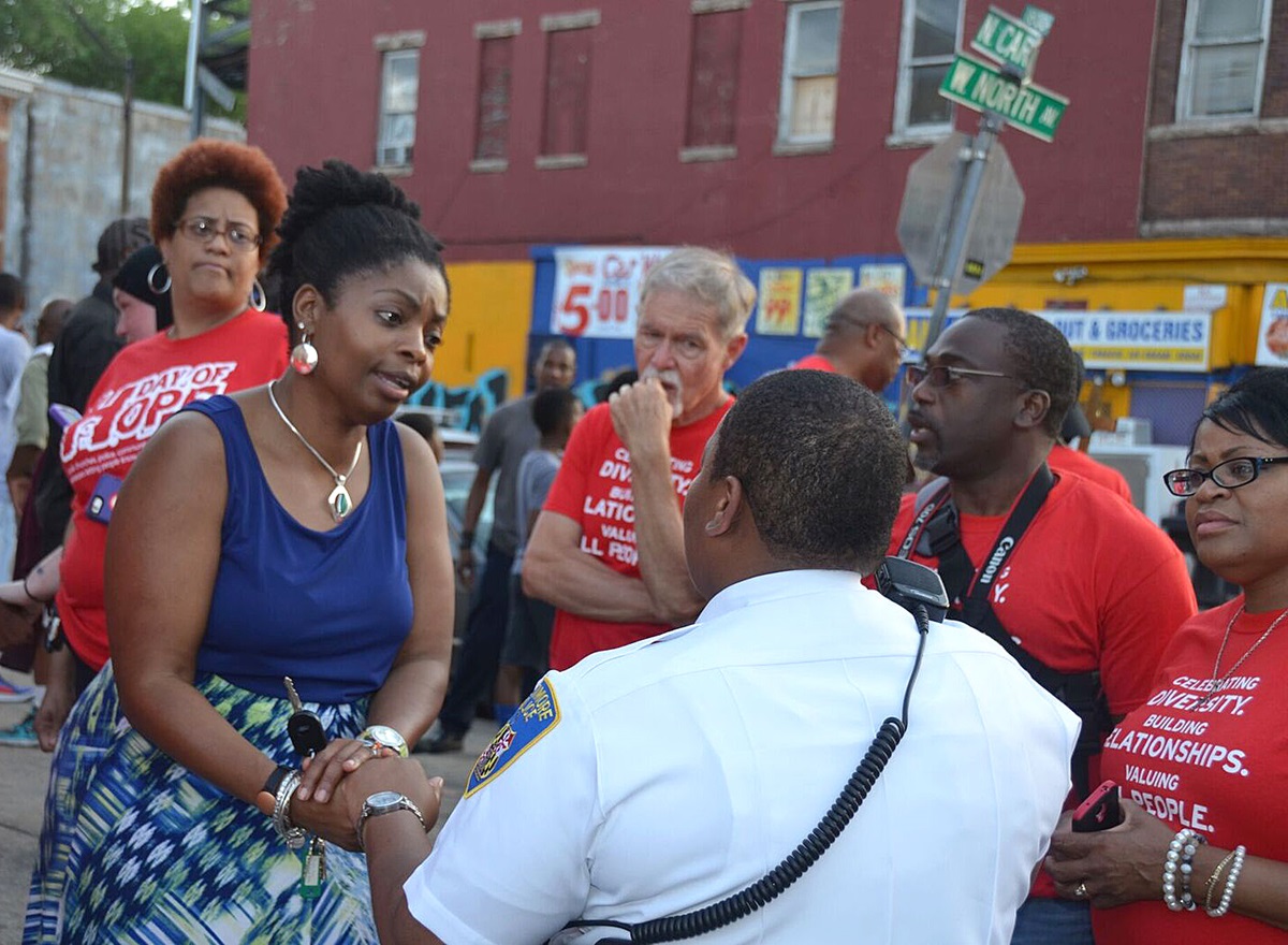 During a prayer walk in Baltimore following days of unrest, the Rev. Cynthia Moore-Koikoi thanks a Baltimore police officer for her service. Moore-Koikoi was elected bishop in July. Photo by Sheila George. 