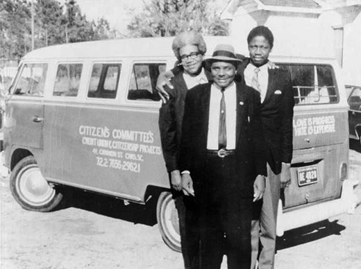 Esau Jenkins, center, stands in front of one of the VW vans he and his wife, Janie, bought to ferry African-American residents of Johns Island to work or school in Charleston, S.C. During the trip, they would teach their passengers the part of the Constitution they needed to know in order to register to vote. Photo courtesy of Elaine Jenkins.