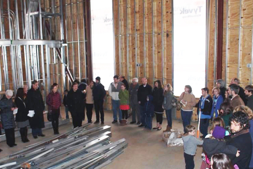 Oconee Street church members gather before drywall is added to cover the sanctuary structure in prayer. Photo courtesy of the Rev. Lisa Caine