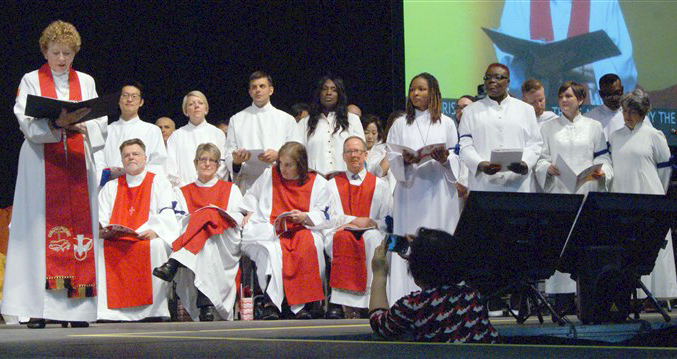 Bishop Jane Allen Middleton, left, examines the candidates for commissioning as elders and deacons during the 217th session of the New York Annual Conference at Hofstra University. Four openly gay candidates were among those commissioned or ordained in June. Photo by Stephanie Parsons, courtesy of New York Conference.