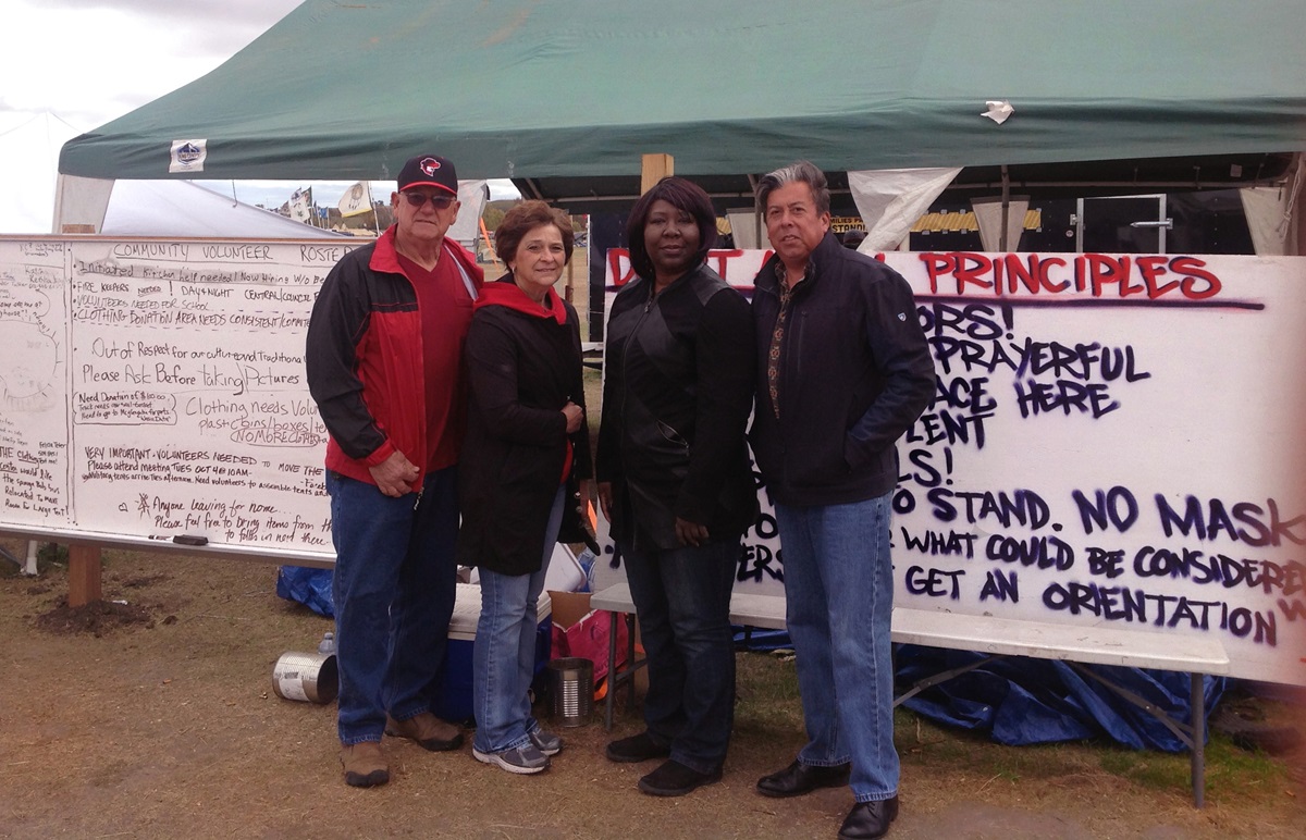 From left, Gary and Louise Niemann from the Great Plains Conference, Erin Hawkins of the United Methodist Commission on Religion and Race and the Rev. David Wilson of the Oklahoma Indian Missionary Conference, visited the campsite in mid-October to support peaceful protests against the pipeline. Photo courtesy of Erin Hawkins, United Methodist Commission on Religion and Race.