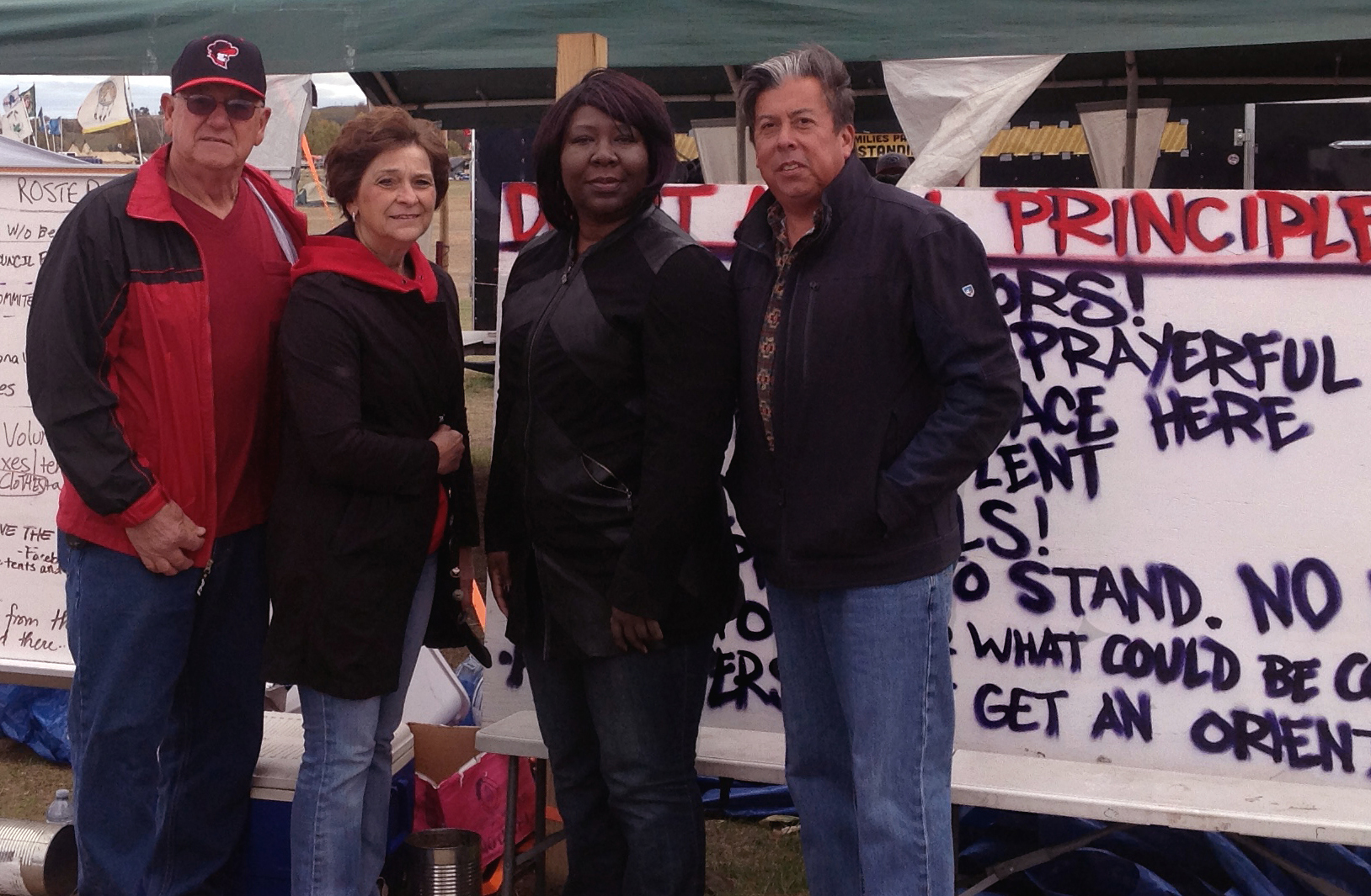 From left, Gary and Louise Niemann from the Great Plains Conference, Erin Hawkins of the United Methodist Commission on Religion and Race and the Rev. David Wilson of the Oklahoma Indian Missionary Conference, visited the campsite in mid-October to support peaceful protests against the pipeline. Photo courtesy of Erin Hawkins, United Methodist Commission on Religion and Race.