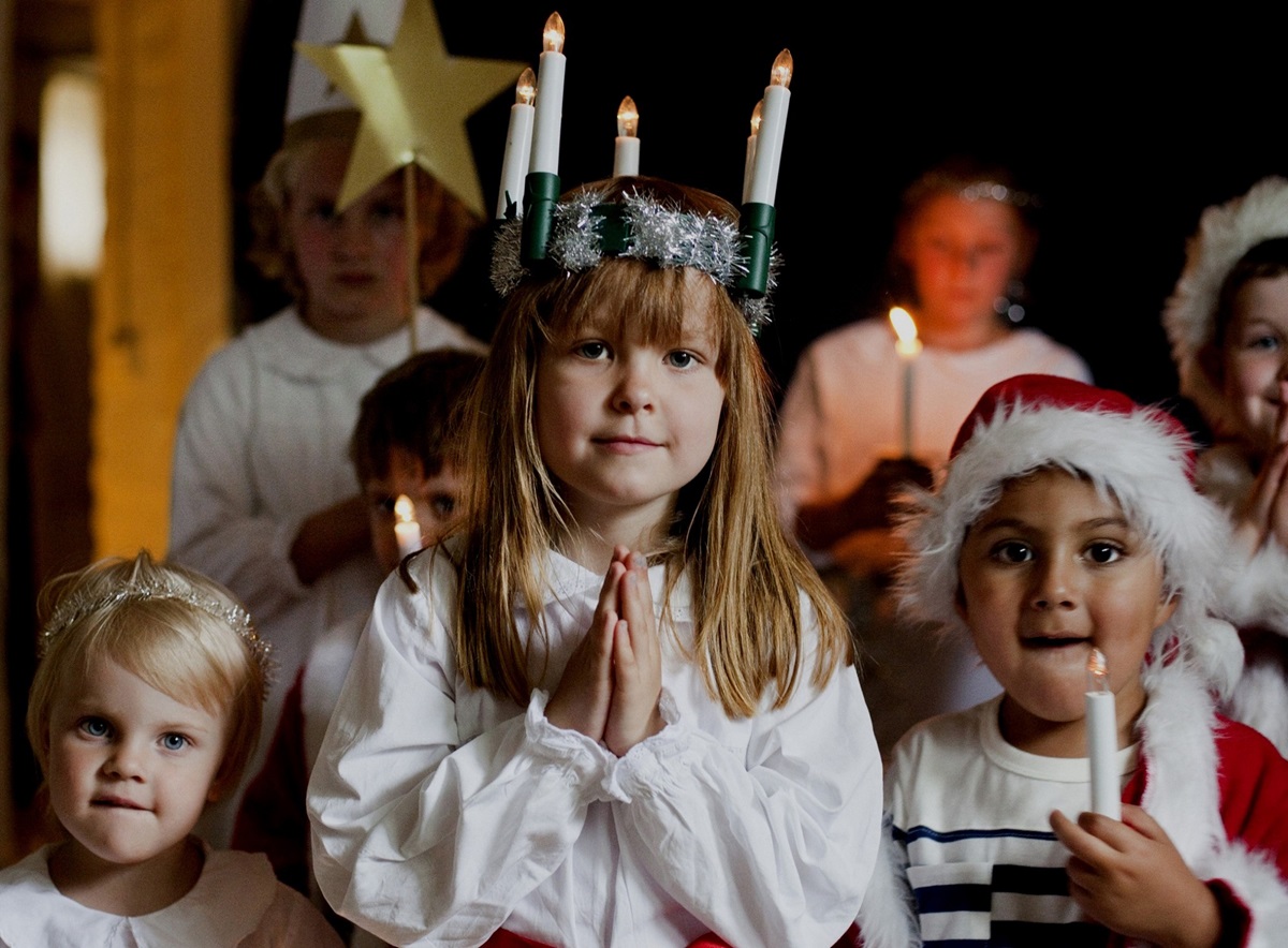 Around Christmas time in Sweden, one of the biggest celebrations is St. Lucia’s Day celebrated by a girl dressing in a white dress with a red sash round her waist and a crown of candles on her head. 