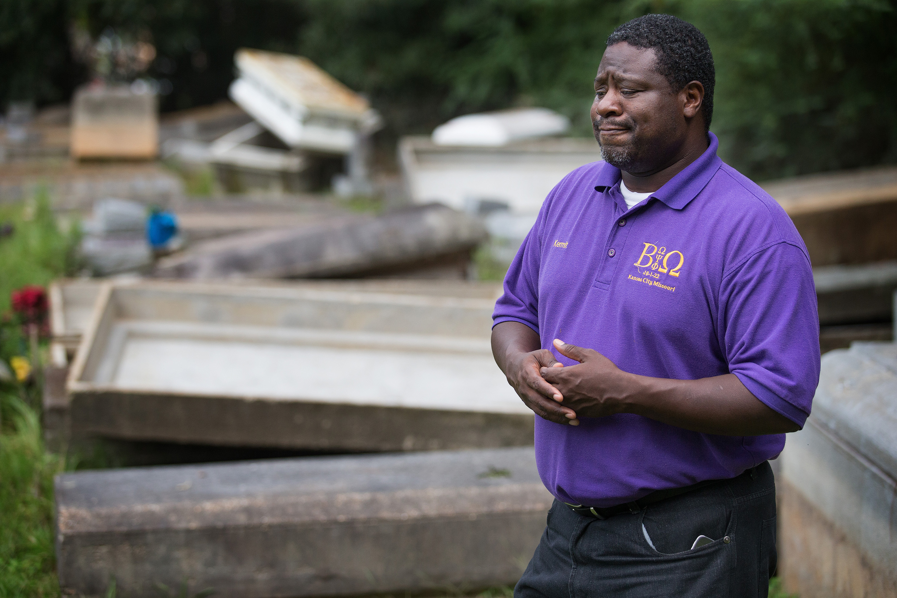The Rev. Kermit Roberson surveys flood damage at Roberts United Methodist Church's Plainview Cemetery in Denham Springs, La., where floodwaters lifted many caskets out of their concrete burial vaults. Photo by Mike DuBose, UMNS.
