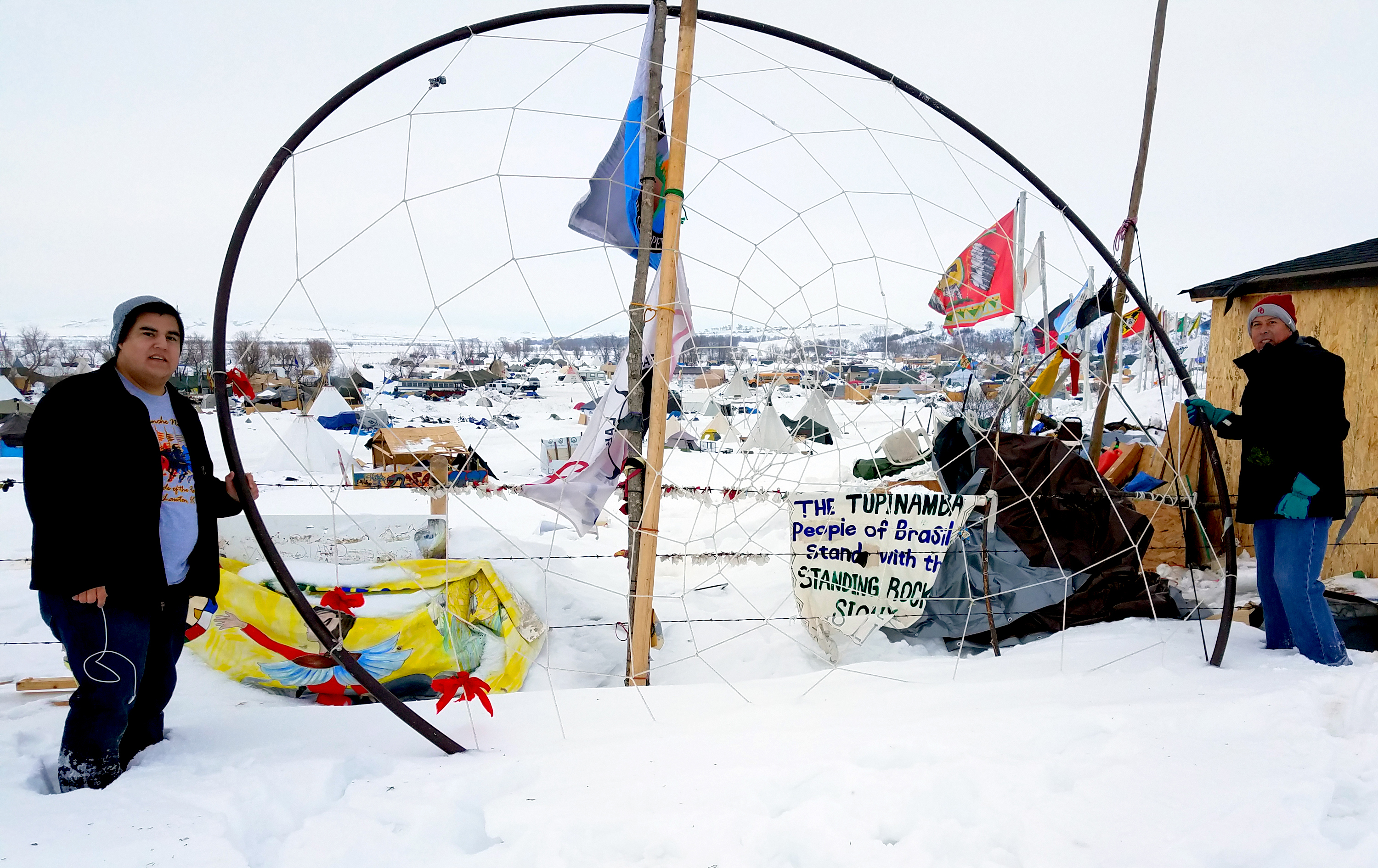While at Standing Rock, the United Methodist group hung tobacco prayer ties on the dream catcher that is located at the entrance to the camp. From left are Dallas Parker and the Rev. David Wilson. Photo courtesy of Dallas Parker.