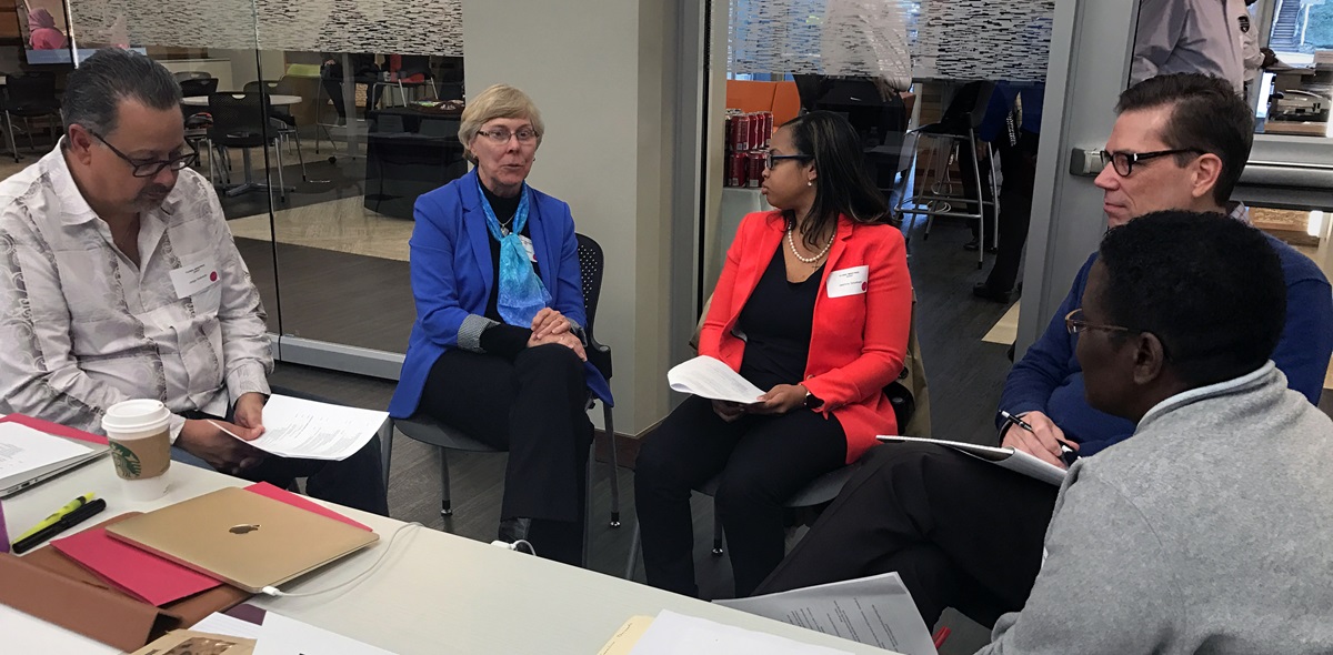 The Rev. Jorge Acevedo (left), Alice Williams, the Rev. Jasmine Smothers, the Rev. Tom Lambrecht and Mazvita Machinga talk together during the first meeting of the Commission on a Way Forward in Atlanta, Jan. 23-26. Photo by Diane Degnan, United Methodist Communications