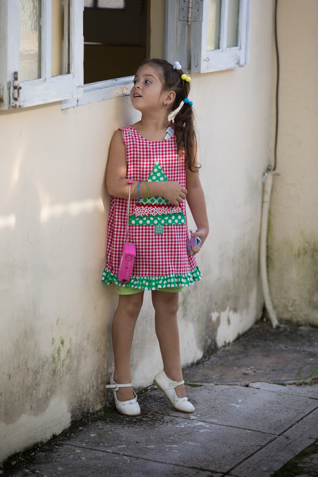 Drema Velazquez-Rodriguez peeks through a window into the San Antonio Methodist Church. Her father is the church pastor. Photo by Mike DuBose, UMNS.