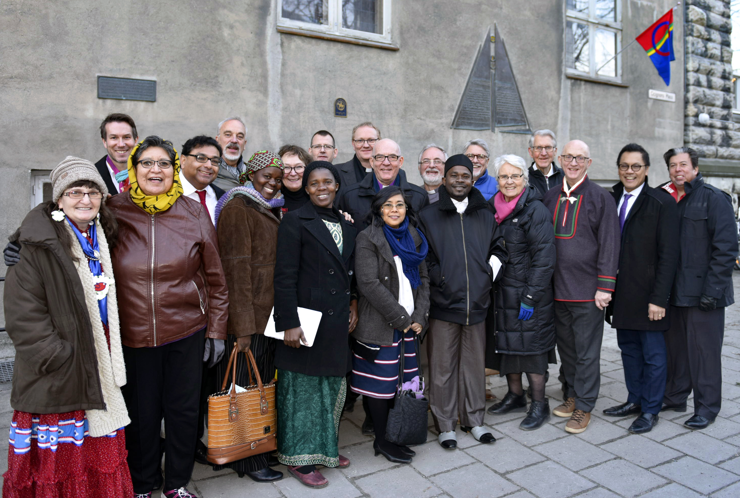 Methodists from Norway and international guests gather outside the Methodist Church in Trondheim, Norway, during the 100-year celebration of the first Sami Congress. The center plaque denotes the church as a United Methodist historic site. Photo by Karl Anders Ellingsen.