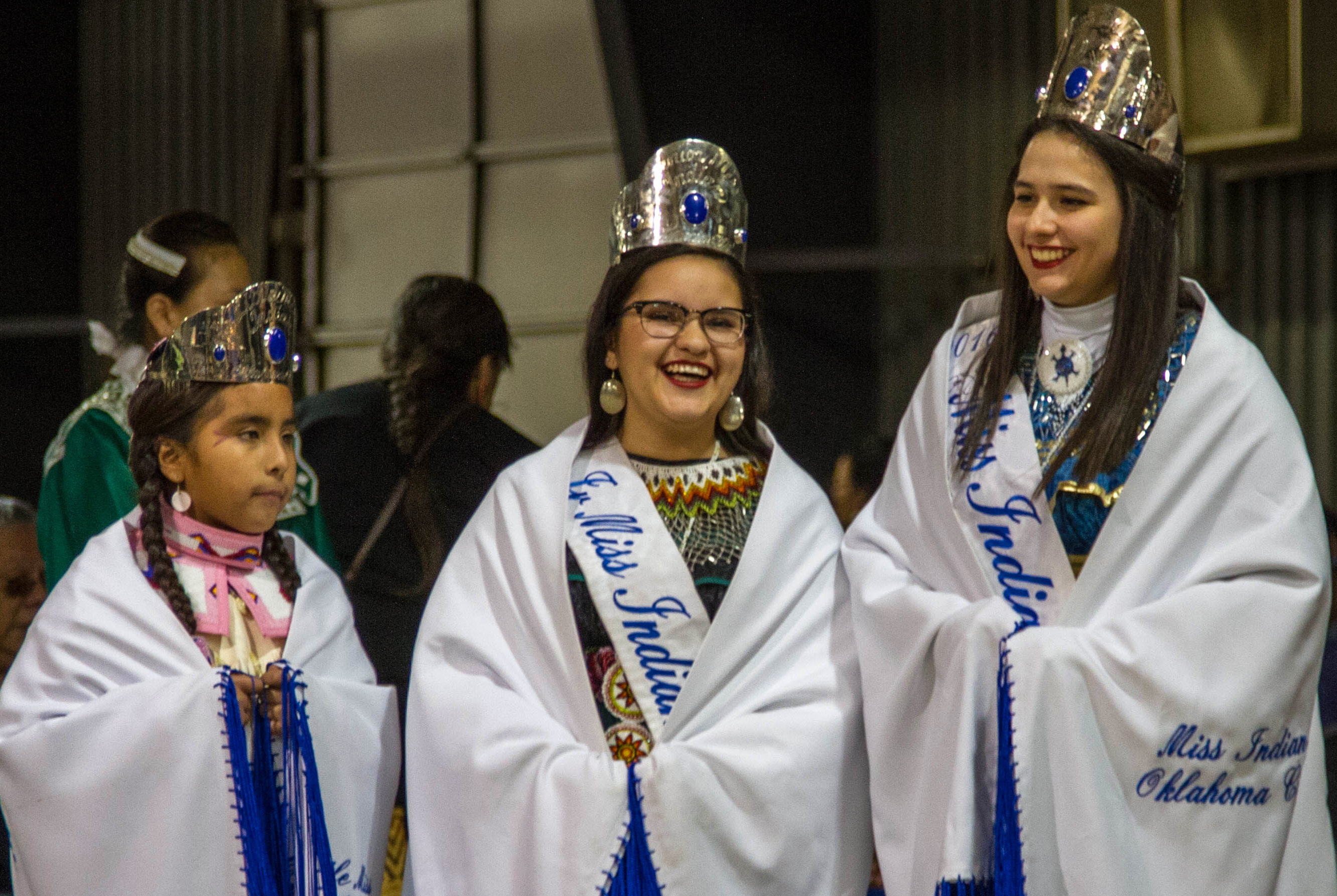 Madeleine Freeman, 2016 Miss Indian Oklahoma City Princess, right, prepares to dance with the 2016 Junior Miss Indian Oklahoma City Princess, Jessica J. Meikle, center, and the 2016 Little Miss Indian Oklahoma City Princess, Victoria Echiwardy, during a pow-wow in Shawnee, Okla., in their honor. Photo by Ginny Underwood, UMNS.