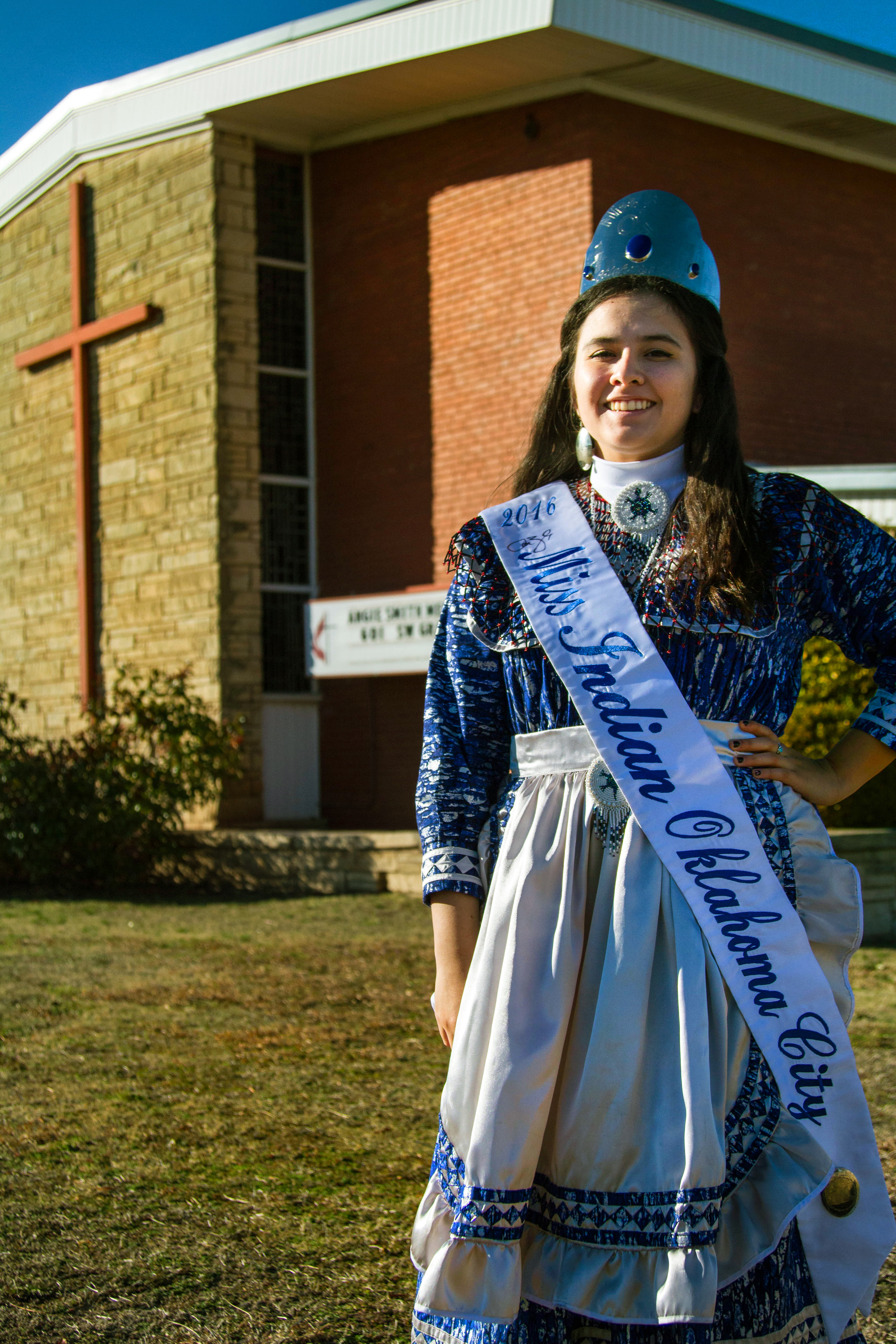2016 Miss Indian Oklahoma City Princess Madeleine Freeman stands in front of her home church, Angie Smith United Methodist Church, a part of the Oklahoma Indian Missionary Conference. Photo by Ginny Underwood, UMNS.