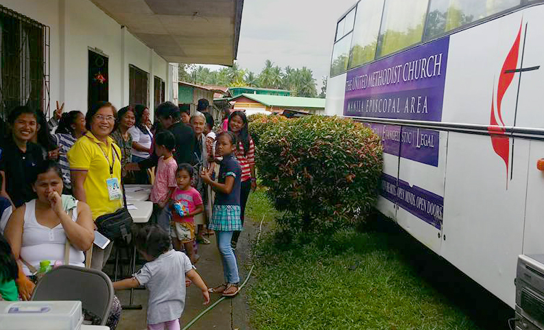 The first United Methodist mobile clinic in the Philippines offered services for the first time on Feb. 20 at Greene Academy, a United Methodist high school in the San Vicinte barangay in the town of Makilala. More than 100 people received medical and dental care from two doctors and four dentists at the clinic. Photo courtesy of Bishop Rodolfo Juan. 