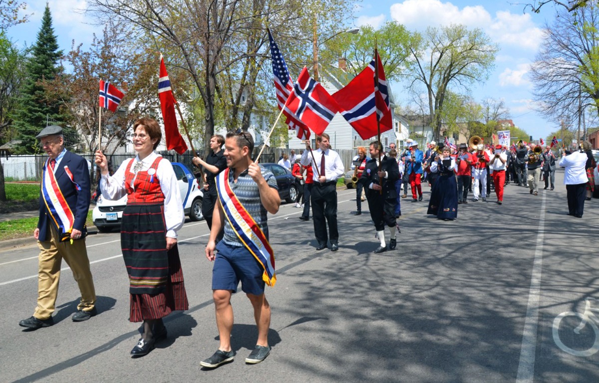 The Rev. Kristin Sundt, front, in traditional Norweigan clothing, leads members of the congregation from Norwegian Lutheran Memorial Church in Minneapolis, Minnesota, known as Mindekirken, in a parade celebrating Norwegian Constitution Day. The church marks the day each year on the weekend closest to May 17. Photo courtesy of Kristin Sundt. 