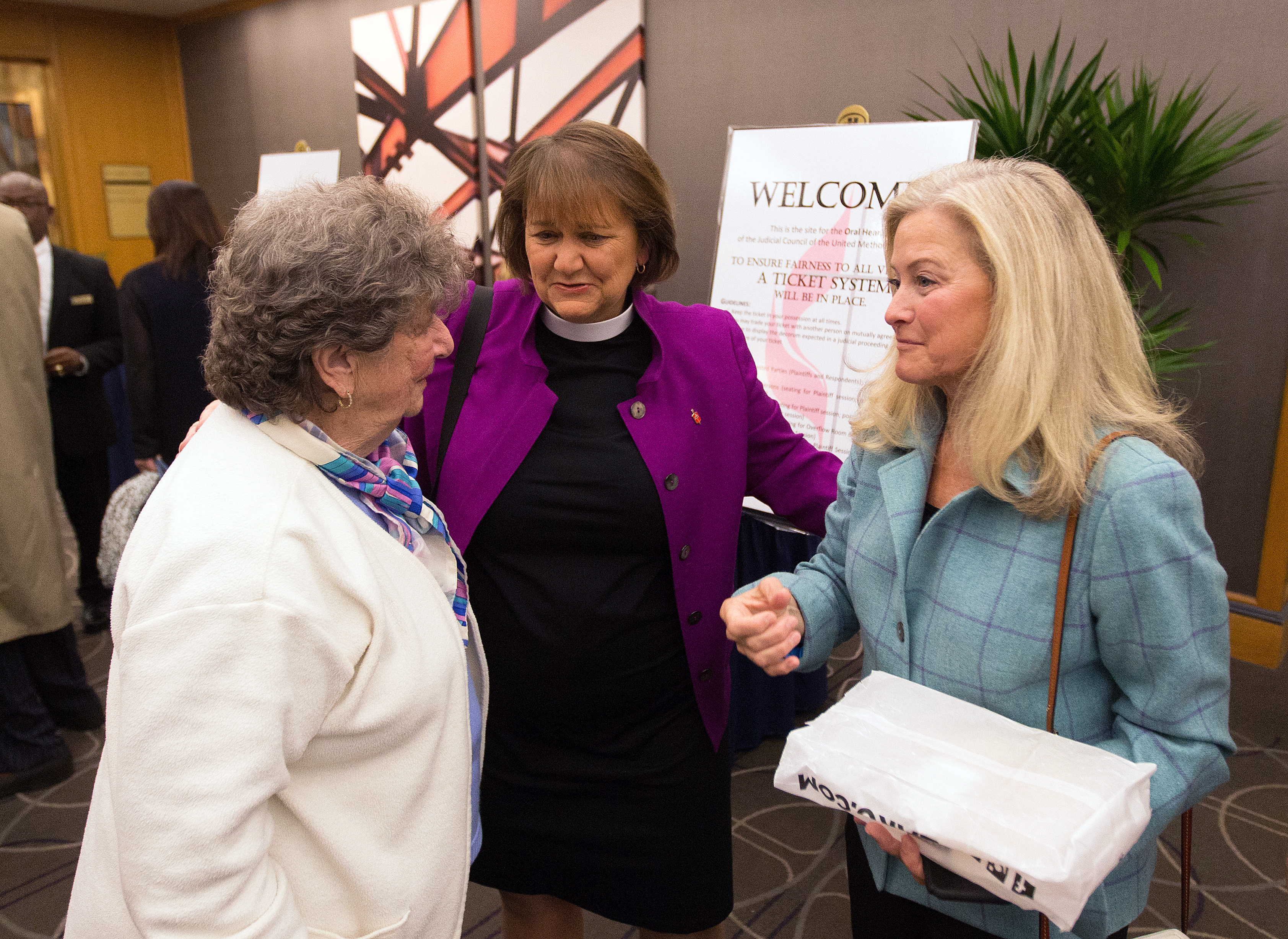 Bishop Karen Oliveto (center) visits with her mother, Nelle Oliveto (left) and her wife, Robin Ridenour outside the April 25 meeting of the United Methodist Judicial Council meeting in Newark, N.J. Photo by Mike DuBose, UMNS.

