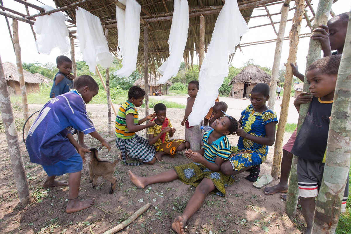 Children groom one another and play with a baby goat in Kanana village, a pygmy community outside Tunda, Democratic Republic of Congo, in October, 2015. Reconciliation between indigenous pygmy tribes and another ethnic group is part of a larger goal for newly elected Bishop Mande Muyombo. File photo by Mike DuBose, UMNS.