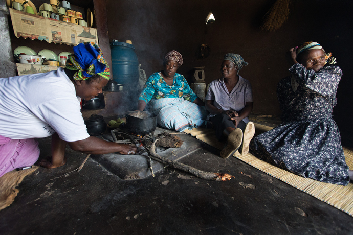 Chaya farmers roast peanuts and corn for a snack as they gather to discuss the challenges of introducing the new plant, native to South America, in Chivi, Zimbabwe. From left are: 
Modesta Manzungo, Sarudzai Mkachana, Regina Mavuko and Sylivia Shuro Kamurai. Photo by Mike DuBose, UMNS.