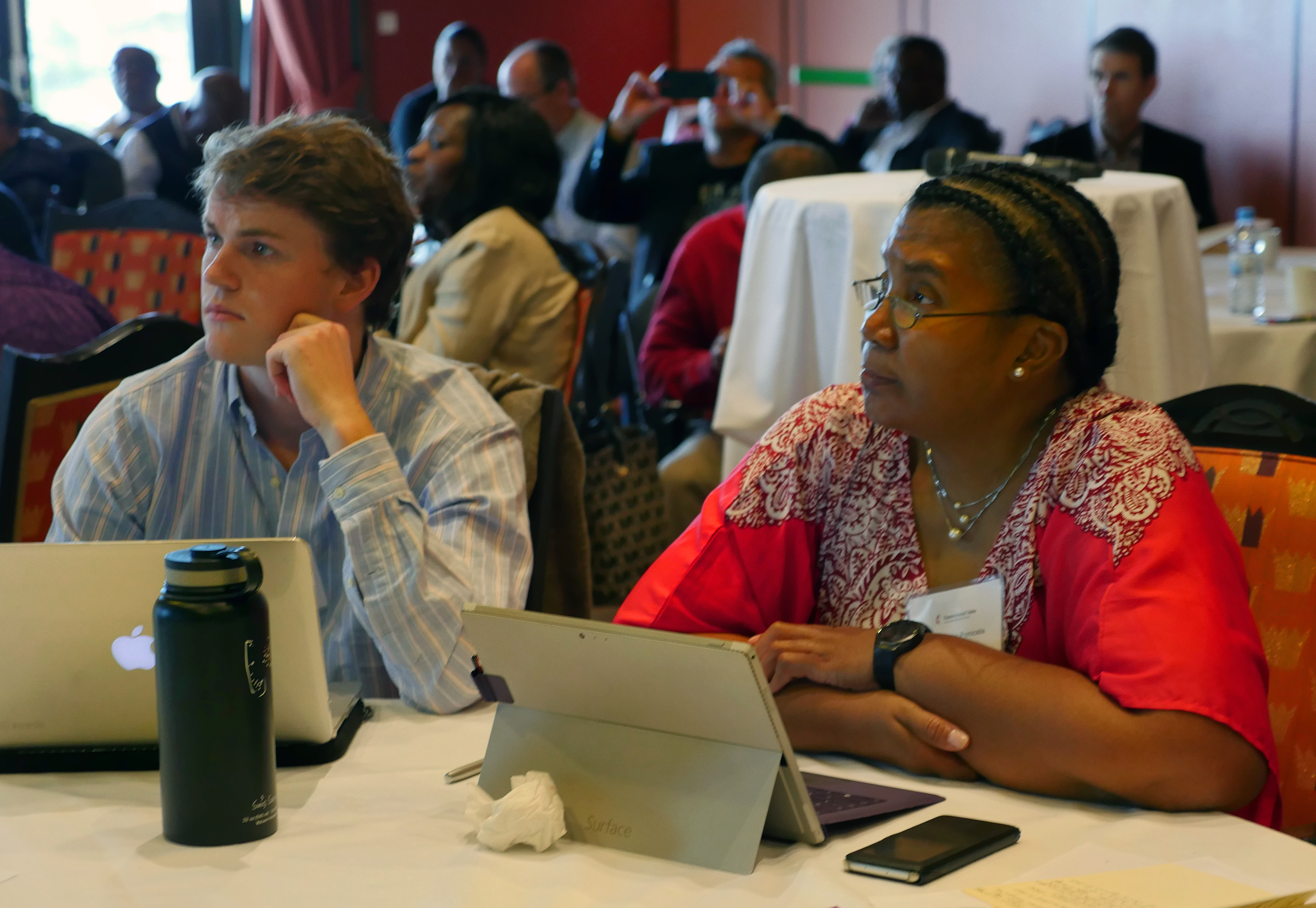 G. Miller Wilbourn, left, of Arkansas, and Benedita Penicela Nhambiu of Mozambique, listen to a presentation at the Connectional Table meeting in Oslo, Norway. Nhambiu leads the Connectional Table’s working group on the denomination’s worldwide nature. Photo by Heather Hahn, UMNS.