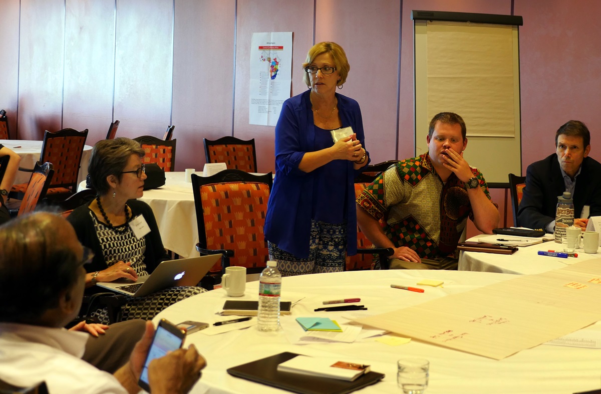 Judi Kenaston, standing, talks with members of the Connectional Table’s advisory group on U.S. matters about ideas for a new U.S. structure. Photo by Heather Hahn, UMNS.