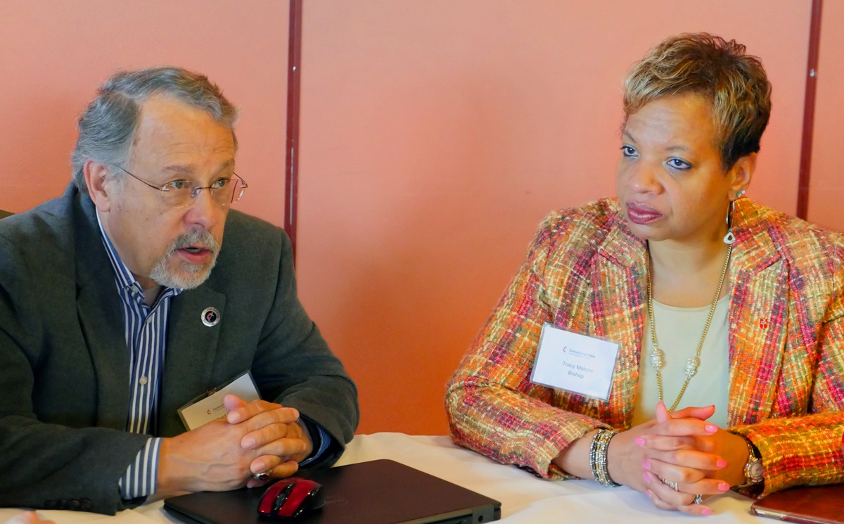 Gil Hanke, top executive of the Commission on United Methodist Men, and Bishop Tracy Malone, president of the Commission on the Status and Role of Women, join in a small-group discussion during the Connectional Table meeting in Oslo, Norway. Photo by Heather Hahn, UMNS.