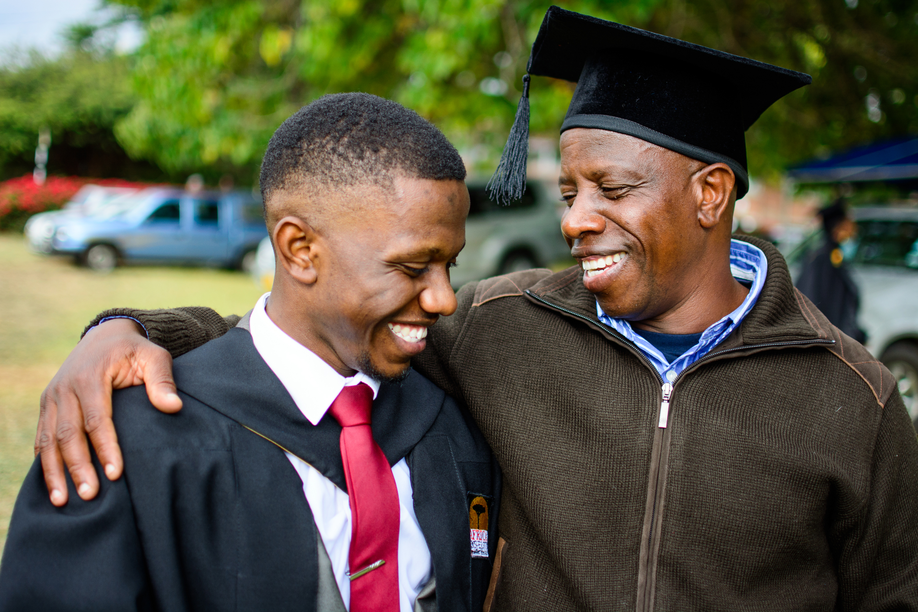Keith Maraini Mudakureva (left) is congratulated by his father during Africa University’s 2017 commencement. Mudakureva graduated with a Bachelor of Science degree in marketing. Photo courtesy of Africa University.
