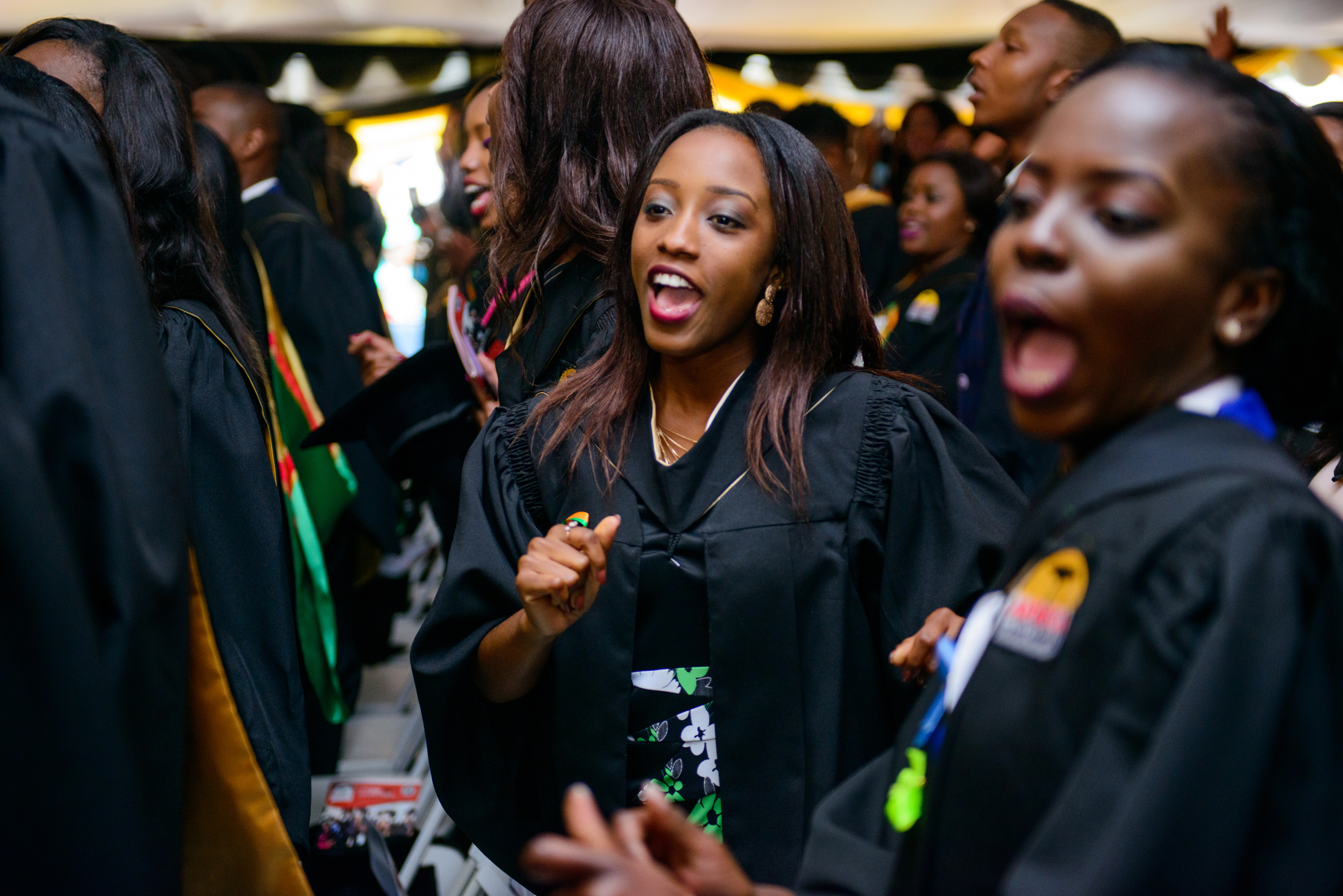 Tsungai Shalom Kaseke (center) who graduated with honors in Psychology, and Ntandoyenkosi Band (right) from the same program, give a shout of joy during their 2017 graduation ceremony at Africa University. Students from 23 African countries received degrees from the United Methodist school in Mutare, Zimbabwe. Photo courtesy of Africa University.