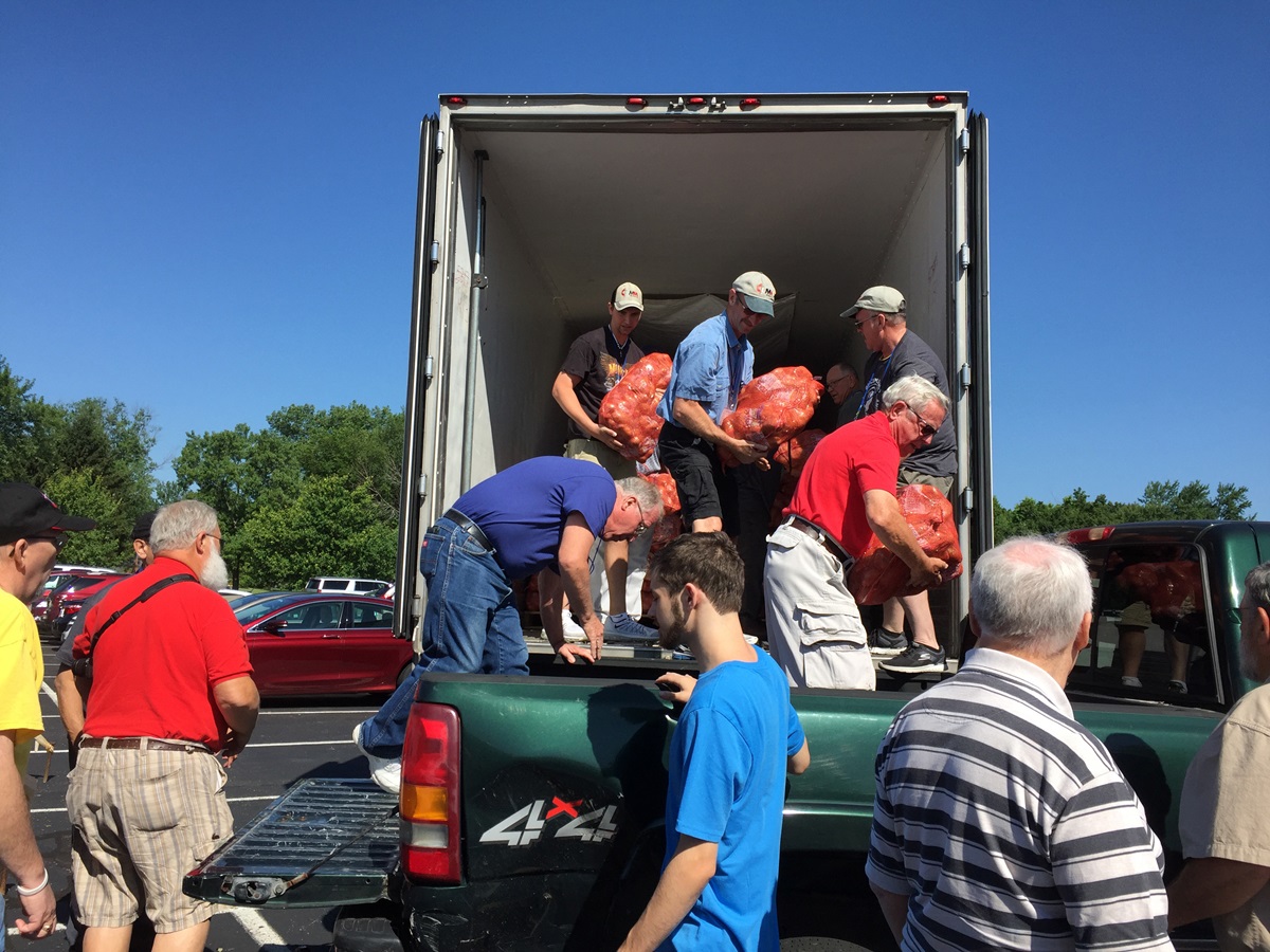 United Methodist Men unload bags of potatoes during their national gathering in Indianapolis. The potatoes will be were distributed to food banks in the Indianapolis area. The men’s ministry has a partnership with the Society of St. Andrew to connect farmers and Americans dealing with hunger. Photo by Heather Hahn, UMNS.