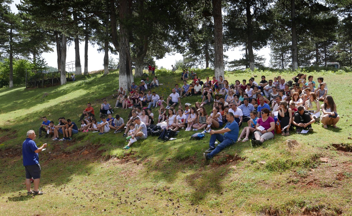 The Rev. Mustafa Isufi (left) speaks to participants of the first national convention of The United Methodist Church in Albania, meeting in Gjinar. Photo by Jean Nausner.
