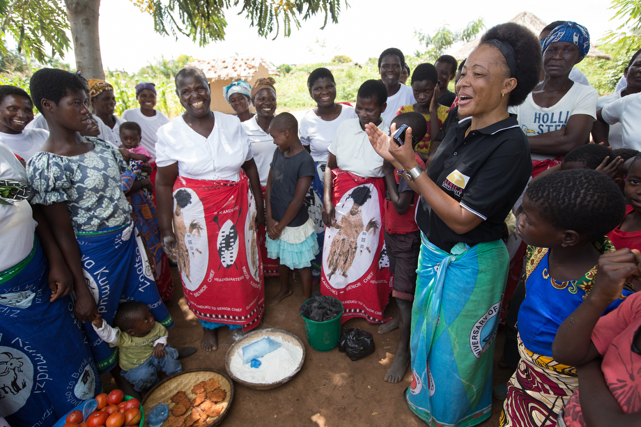 Mercy Chikhosi (in black shirt) regularly visits with the women of Nkhafi village in Malawi. She has an easy rapport with members of the village. “I developed a strong bond and a relationship so I continue visiting, influencing and motivating them to identify their needs and find solutions with local resources,” Chikhosi said. Photo by Mike DuBose, UMNS.
