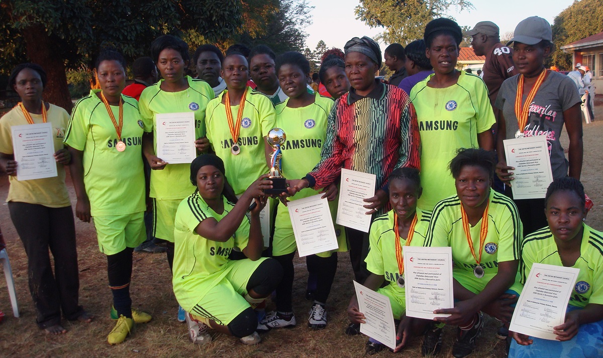 The wining soccer team from the Domboramwari Circuit pose with their trophy during a sports gala held at Selborne Routledge Primary School in Harare. The two United Methodist conferences in Zimbabwe competed in a sports event aimed at promoting exercise for health. Photo by Kudzai Chingwe, UMNS.