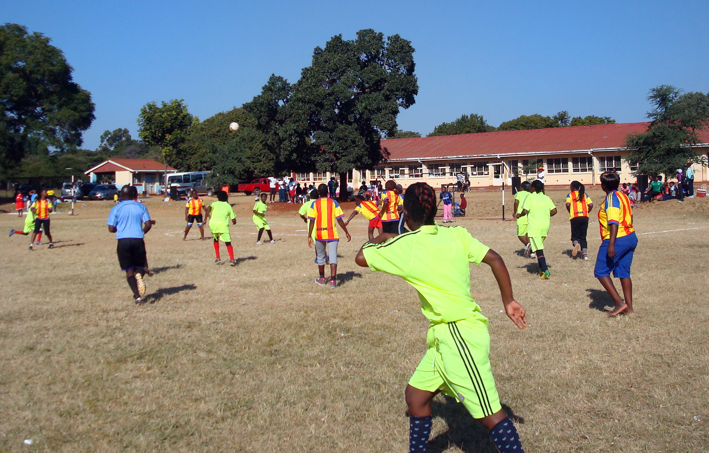Opposing teams rush for the ball in the final soccer match between the Domboramwari Circuit team and the Harare West District Team at Selborne Routledge Primary School in Harare, Zimababwe. The match was part of a sports event sponsored by Zimbabwe Episcopal Area women’s organization, RukwadzanoRweWadzimai. Photo by Kudzai Chingwe, UMNS.