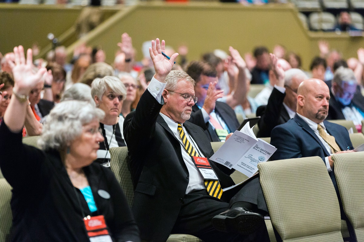 Members participate in the Alabama-West Florida Annual Conference in Montgomery, Ala., including the Revs. Nancy Watson (front row, left), Doug Pennington and Allen Newton. The conference was one of 17 that approved a resolution related to welcoming migrants. Photo by Luke Lucas, Alabama-West Florida Conference.