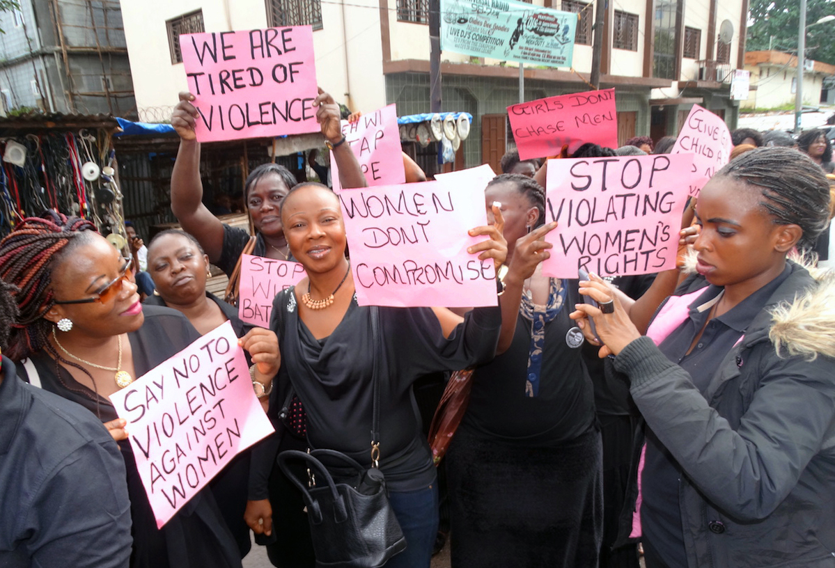 United Methodist Women hold up placards with inscriptions calling for an end to violence against females in Freetown on July 27. The women from the Sierra Leone Annual Conference took to the streets to protest against the growing violence against women and girls in the country. 