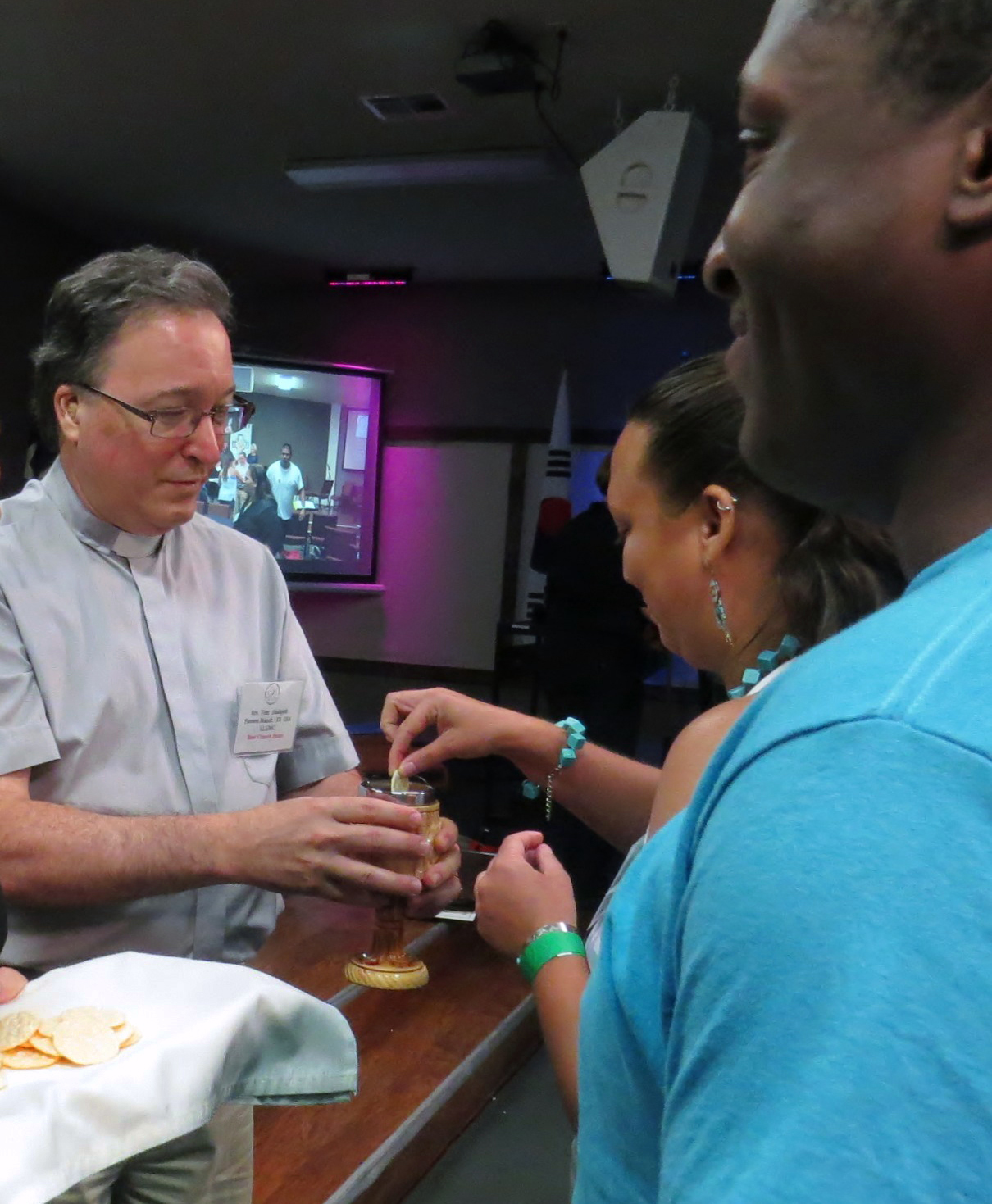 The Rev. Tom Hudspeth offers communion during the Aug. 1, 2017, opening worship service at the Global Methodist Missions Conference of the Deaf, in Waxahachie, Texas. Photo by Sam Hodges, UMNS.