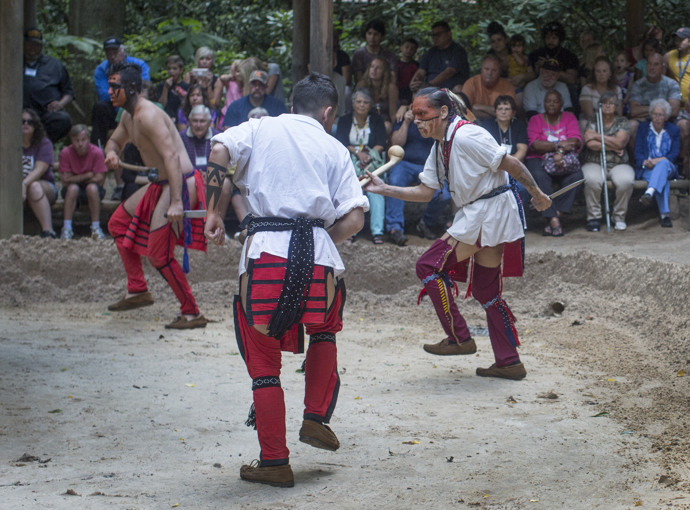 An audience (including conference attendees) watches a reenactment at the Oconaluftee Indian Village in Cherokee, N.C. Photo by Kathleen Barry, UMNS.