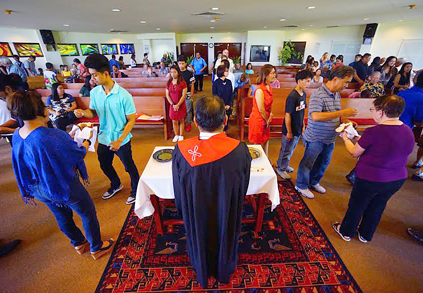 Members of Guam United Methodist Church partake in communion on Pentecost Sunday, June 4. Guam is a U.S. territory in the Pacific that has been threatened with a nuclear missile strike by the leader of North Korea, Kim Jong Un. The Rev. Johann M. Osias, senior pastor, said a similar threat was made in 2013. Photo courtesy of Hiro Kurashina.